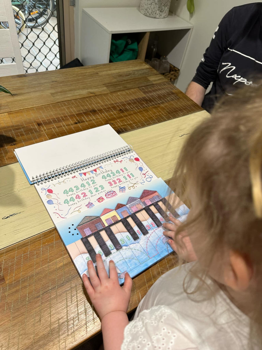 Girl uses piano beach piano teaching story book